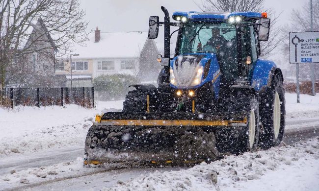 An image of Total Gritting Solutions tractor snow plough out doing snow clearance